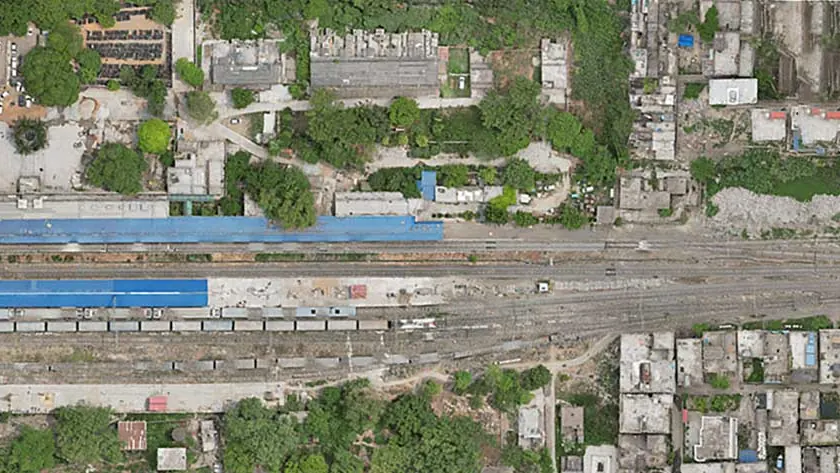 Drone orthomosaic of the east end of a station yard with tracks, platform and surrounding buildings