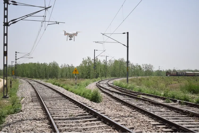 A survey drone flying over a railway track