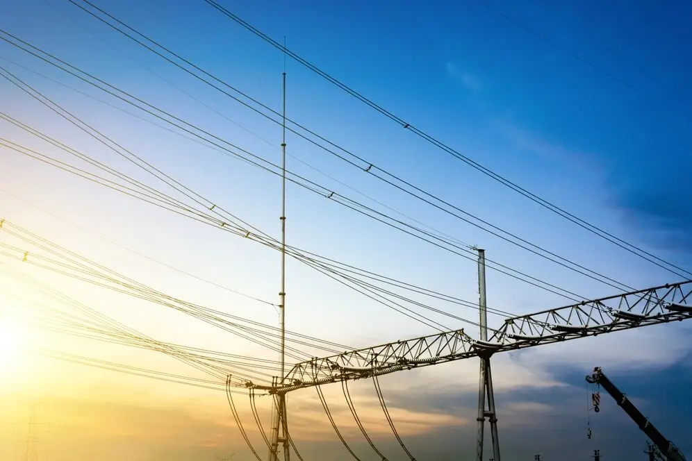 High-voltage transmission towers and conductors against the sky