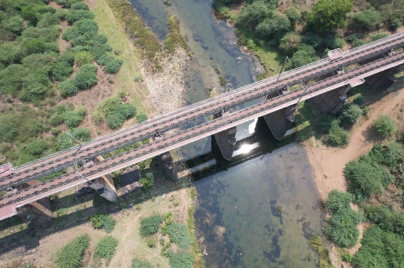 Railway bridge across a river channel, mapped from the air